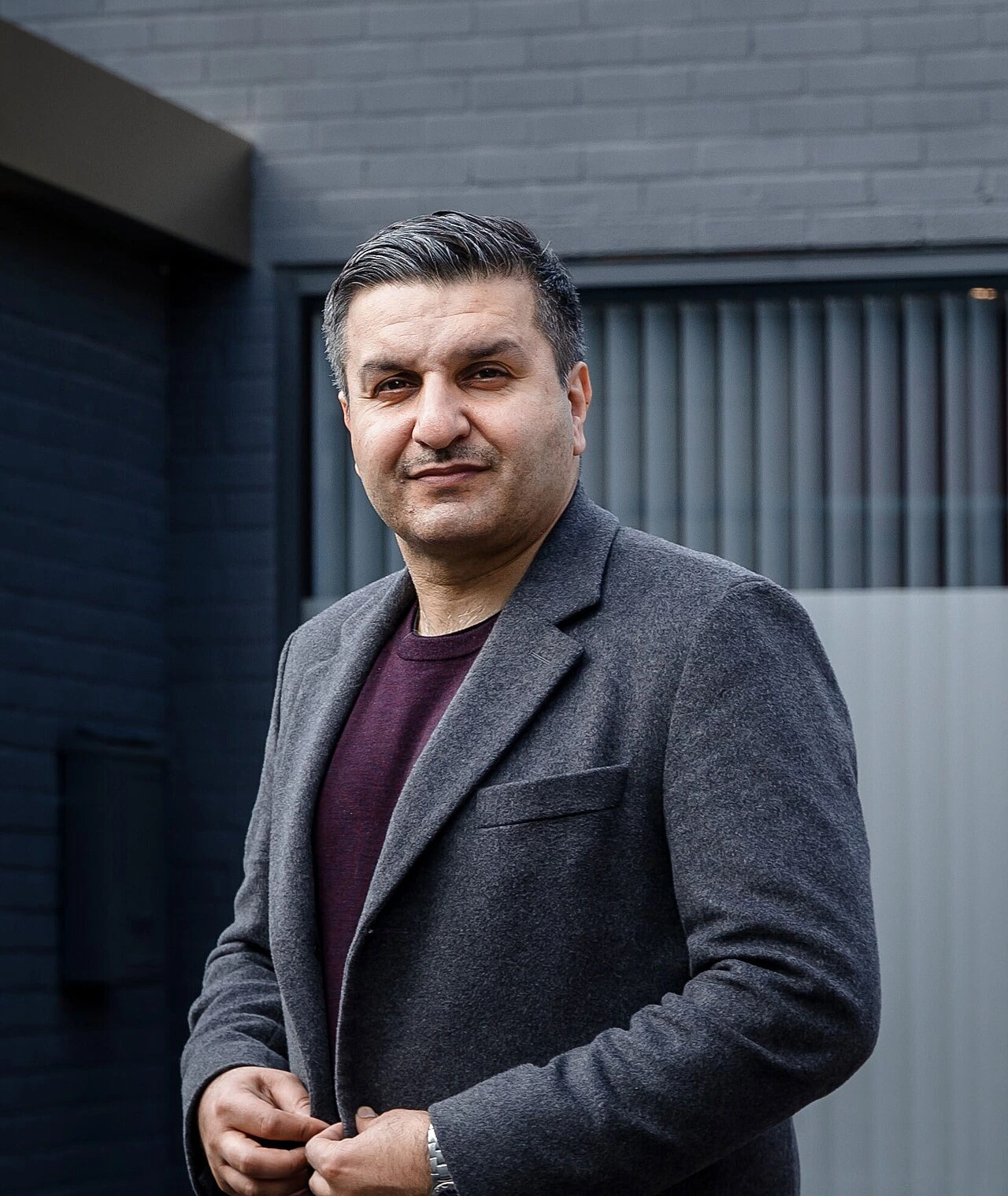 Frank Khalid standing outdoors in front of a building
